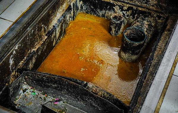 putting off grease trap cleaning can result in foul odors, clogs, and even fines for non-compliance with regulations